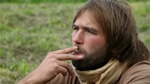 Young man smoking a cigarette Stock Footage 8562287