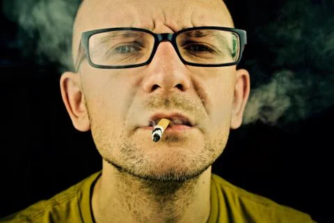 Young man smoking cigarette Stock Photos