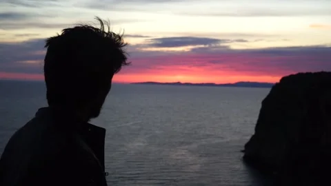 Young man smoking a cigarette while watching the sunset Stock Footage 131151458