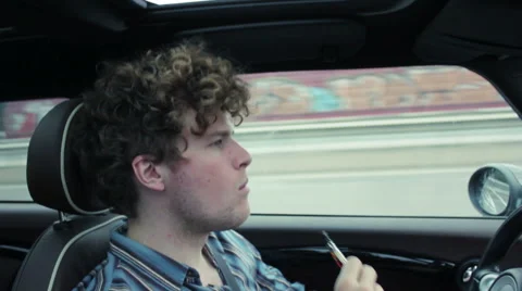 Young man smoking e-cigarette while driving Stock Footage 41545873