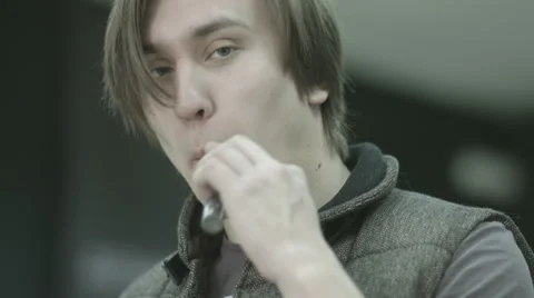 Young man smoking electronic cigarette Stock Footage 64765294
