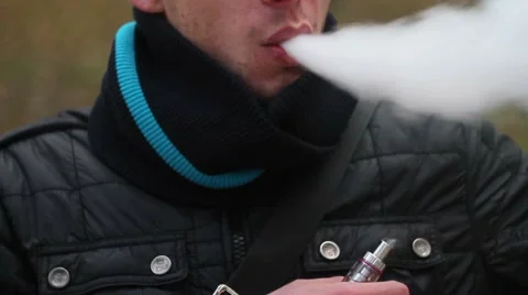 Young man smoking electronic cigarette Stock Footage 68894590