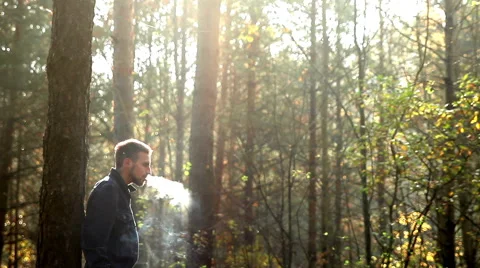 Young man smoking in forest Stock Footage 42778298