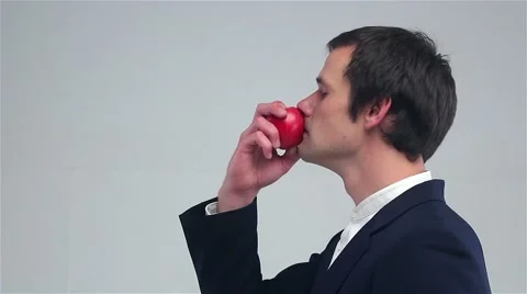Young man sniffing an apple Stock Footage 69001514