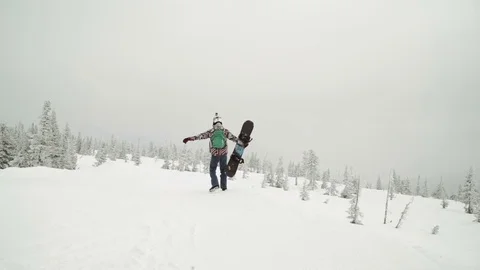 Young man snowboarder posing over winter forest. Outdoor winter portrait over Stock Footage 73462974
