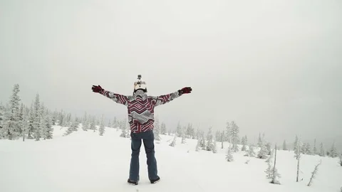 Young man snowboarder posing over winter forest. Outdoor winter portrait over Stock Footage 73463046