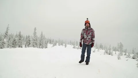 Young man snowboarder posing over winter forest. Outdoor winter portrait over Stock Footage 73463114
