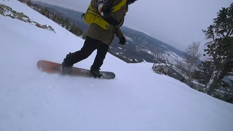 Young man snowboarding in the moutain off track Stock Footage
