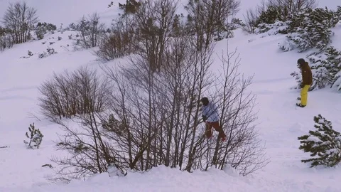 Young man snowboarding through trees in slow motion Stock Footage 85365159