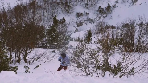 Young man snowboarding through trees in slow motion Stock Footage 85365822