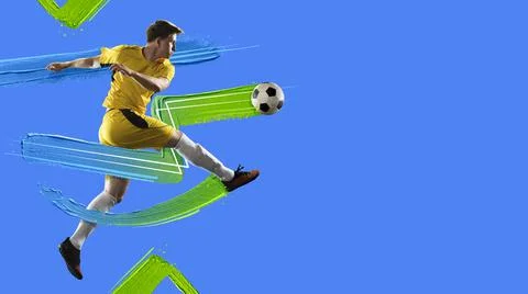 Young man, soccer footbal player kicking the ball isolated in neon light on blue Stock Photos