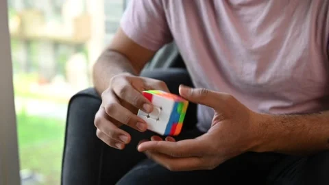 Young man solving a Rubiks cube long clip 4 Video stock 154211644