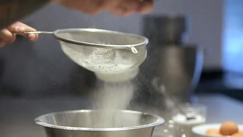 The young man soweth flour for making cake. Stock Footage 72073396