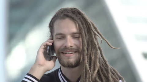 A young man is speaking on the phone Stock Footage 64967992