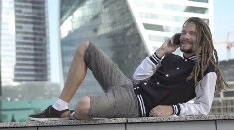 A young man is speaking on the phone Stock Footage 65083097