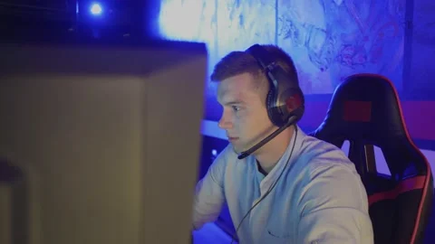 Young man spending time in modern e-sport club playing shooter video game Video stock 136379831