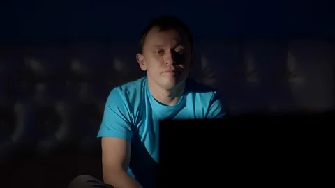 A young man spends a boring evening alone on TV Stock Footage 128665624