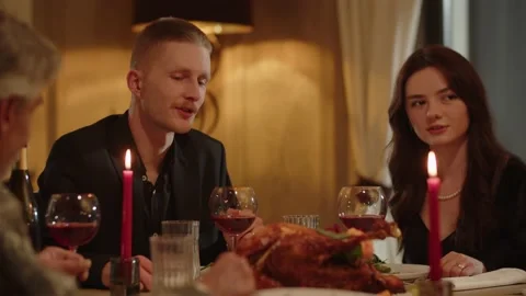 A young man spends time with his family over dinner at a restaurant. A man in Stock Footage 237760627