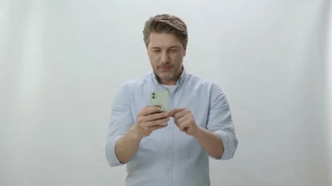 A young man spends time on the Internet with a smartphone Stock Footage 198360293