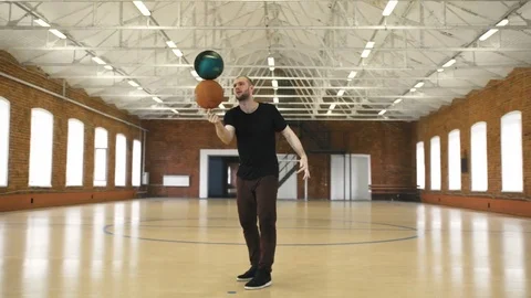 Young man spinning 2 balls on finger Stock Footage 79417569