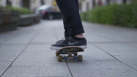 Young Man Spins his skateboard and rides Stock Footage