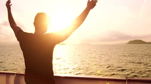 Young Man Spiritual Worship Pose Outstretched  Arms Sun Cruise Ship Water Sunset Stock Footage