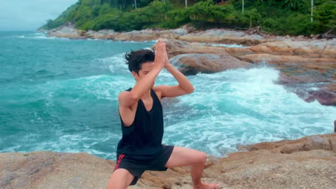 Young man in sportswear doing martial art , Qigong , Tai chi on the rock at s Video stock 201212917