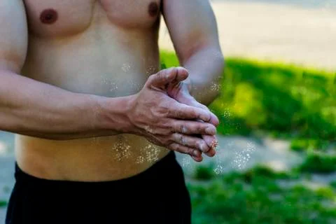 The young man sprinkle his hands with powder Stock Photos