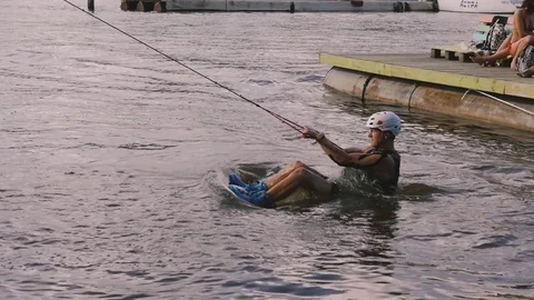 Young man sprints on wakeboard Stock Footage 69850312