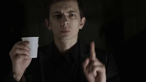 A young man squeezes a plastic cup and says no to the plastic. Ecology Stock Footage 120597341