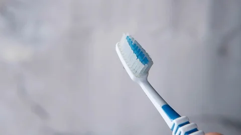 Young man squeezing toothpaste onto the toothbrush. Stock Footage 128939737