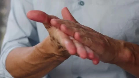 Young man squeezing a white moisturizer from a tube on his hand close-up Stock Footage 258376085