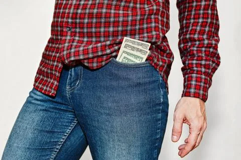 Young man with stack of dollars in pocket Stock Photos