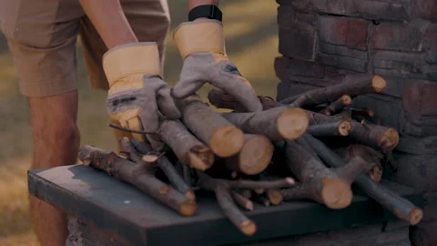 Young man stacking firewood close-up Video stock 287673482