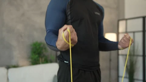 Young man stand and exercise with rubber resistance elastic band Stock Footage 278333000