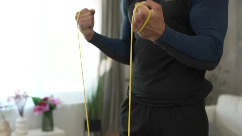 Young man stand and exercise with rubber resistance elastic band Stock Footage 278333043