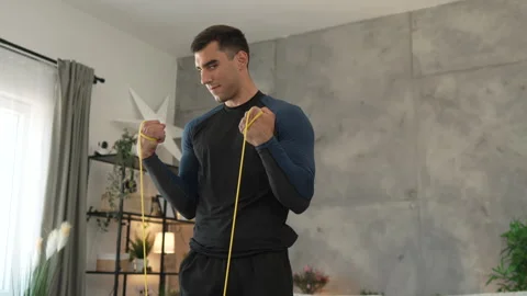 Young man stand and exercise with rubber resistance elastic band Stock Footage 278333044