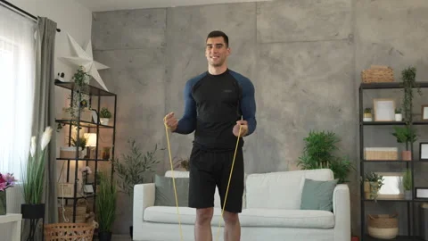 Young man stand and exercise with rubber resistance elastic band Stock Footage 278333057