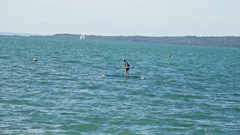 Young man stand up paddle boarding in the sea Stock Footage 87807221