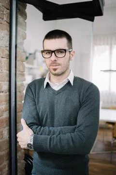 Young man standing alone with hands crossed Stock Photos