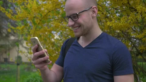 Young man standing and using mobile phone. Close up. Video stock 62519750