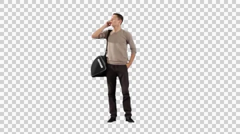 Young man standing with bag and calling by phone Video stock 43260157