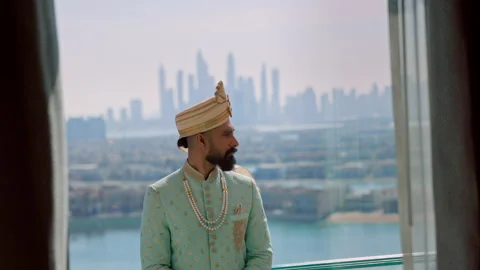 Young Man Standing On The Balcony. Behind Him View Of The Dubai.. Man In Blue Stock Footage 153773015