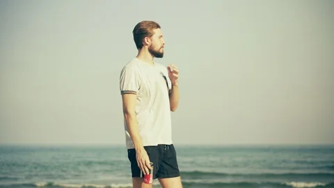Young Man Standing on Beach Stock Footage 129282377