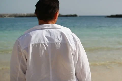 Young man standing on the beach  NTSC Stock Footage 10901821