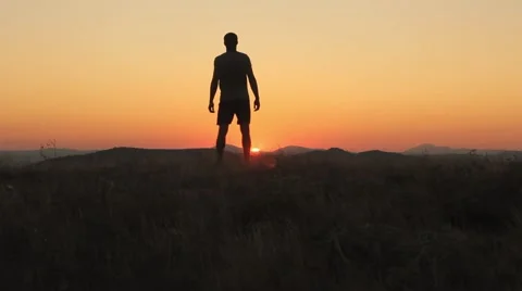 Young Man Standing On a Beautiful Sunset Stock Footage 55838760