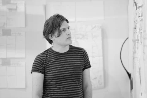 A young man is standing at the booth developing concepts of business. Stock Photos