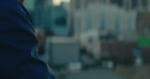 Young man standing on a bridge looking out at the sunset Stock Footage 279357685