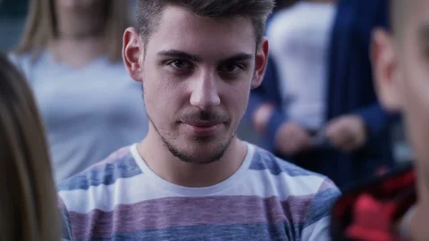 Young man standing in crowd Stock Footage 118111993