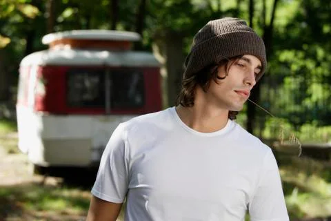Young man standing in front of camper Stock Photos